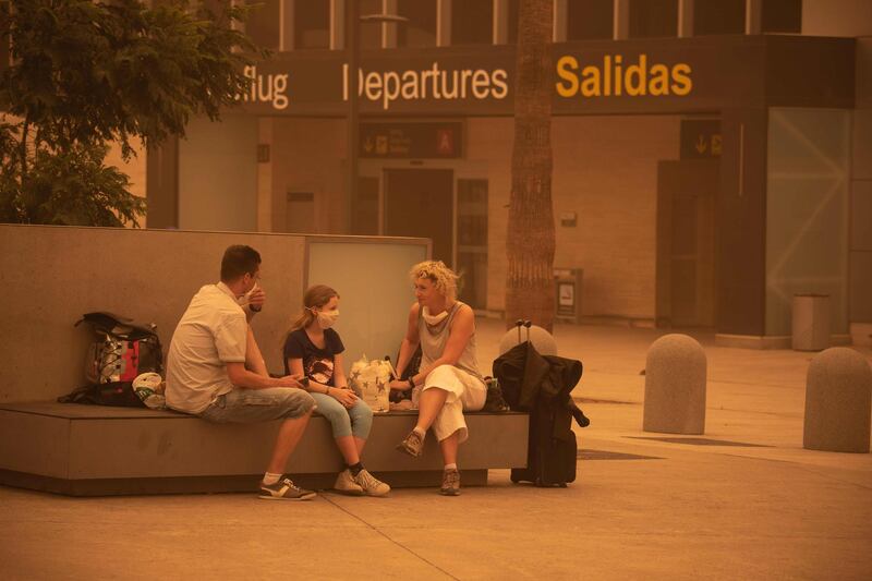 Passengers wait outside Tenerife South–Reina Sofia Airport after flights were cancelled due to a sandstorm on February 23, 2020 on the Canary Island of Tenerife. AFP