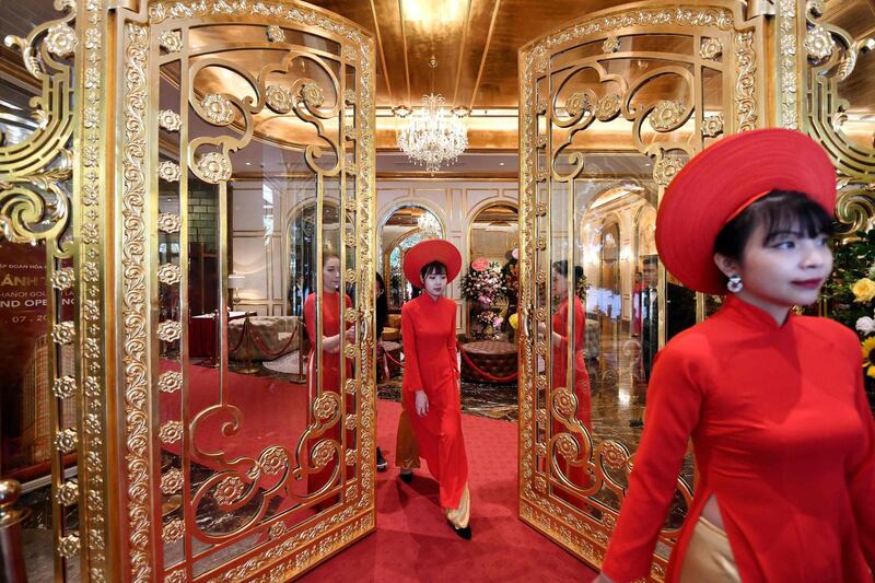 Staff wait to welcome guests in the lobby of Hanoi Golden Lake hotel. AFP