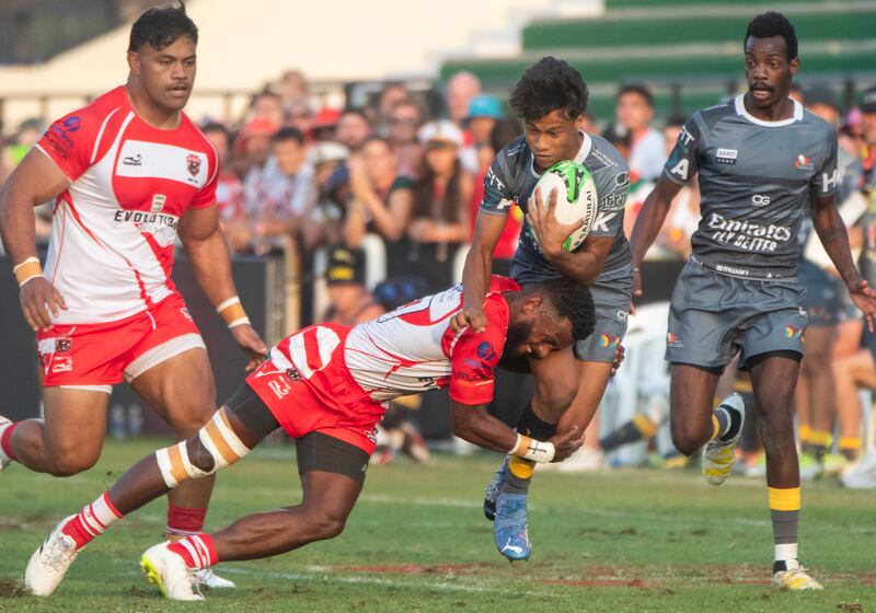 A Dubai Hurricanes player is tackled.