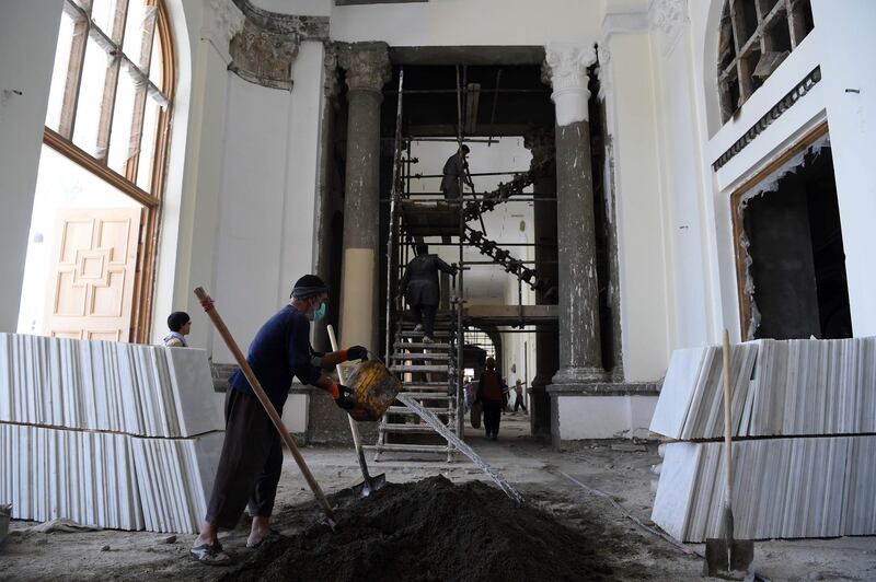 In this photo taken on August 1, 2019 Afghan labourers work on the renovation of Darulaman Palace in Kabul. Work to completely renovate the once-ruined Darulaman Palace must be completed by August 19, the date marking 100 years of Afghan independence from Britain, when President Ashraf Ghani will inaugurate the newly finished structure that has came to reflect the country's turmoils during decades of war. - To go with 'AFGHANISTAN-HISTORY-CENTENARY,FOCUS' by Thomas WATKINS
 / AFP / WAKIL KOHSAR / To go with 'AFGHANISTAN-HISTORY-CENTENARY,FOCUS' by Thomas WATKINS
