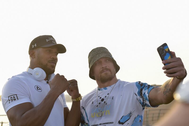 Ukraine's Oleksandr Usyk, right, and Britain's Anthony Joshua pose for a selfie after the press conference to announce the heavyweight boxing rematch for the WBA, WBO, IBO and IBF titles in Jeddah on June 21, 2022. AFP