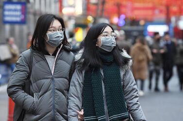 People wear face masks in London, Britain. EPA/ANDY RAIN