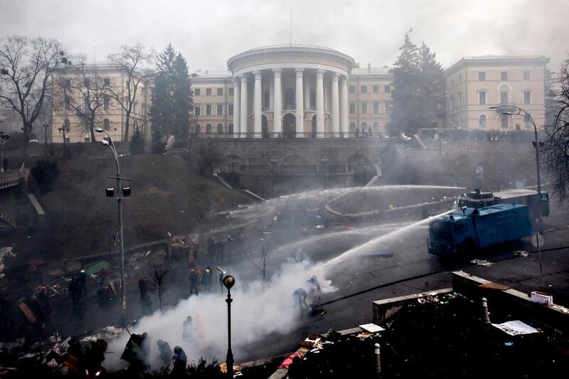 Police use water cannon against anti government demonstrators during clashes with riot police. Yevgeny Maloletka / EPA