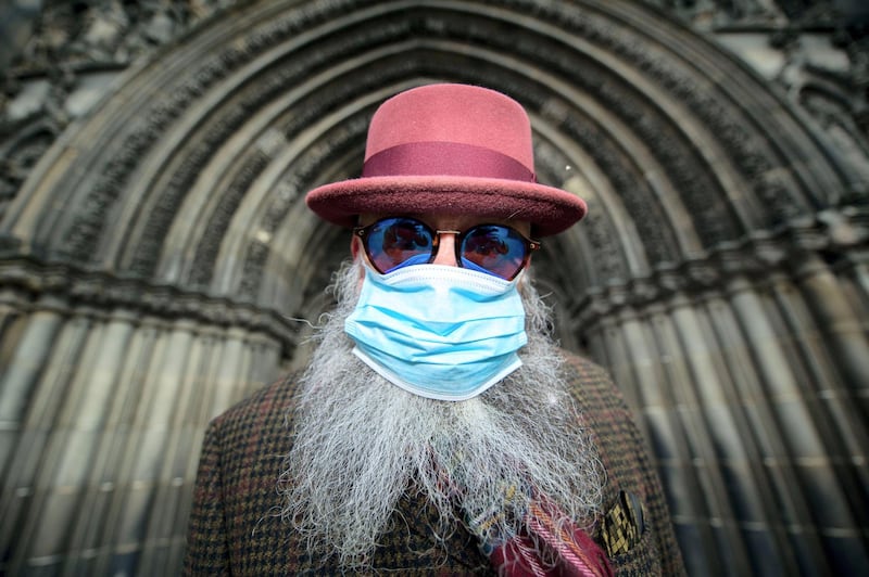 2B744MX Edinburgh, UK. 13th Mar, 2020. Pictured: Man seen wearing surgical mask and covering his nose and mouth due to the Coronavirus pandemic. Credit: Colin Fisher/Alamy Live News