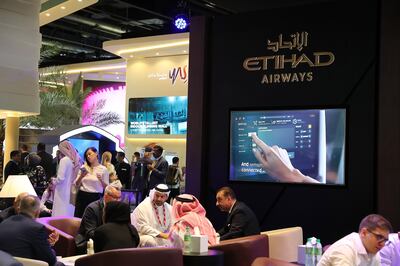 Visitors at the Etihad stand at the Arabian Travel Market in Dubai. Pawan Singh / The National