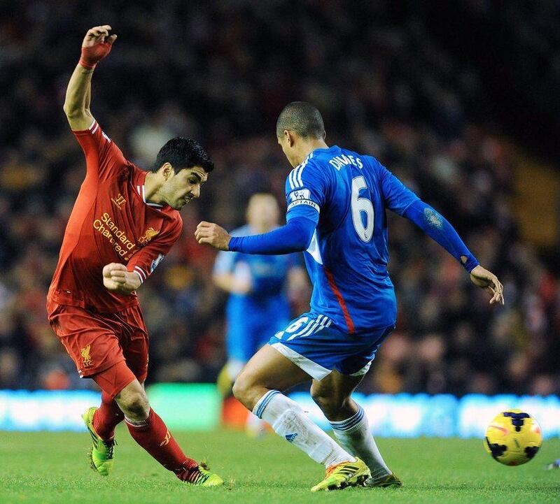 Liverpool's Luis Suarez, left, in action against Hull City's Curtis Davies during their English Premier League match at Anfield Road stadium in Liverpool on Wednesday. EPA/PETER POWELL