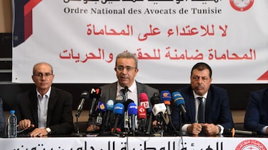 Hatem Meziou, centre, president of the Tunisian Lawyers’ Bar, condemned the police raids at a press conference in Tunis on Tuesday. AFP