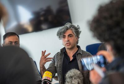 Co-plaintiff, Syrian Oscar-nominated filmmaker Feras Fayyad answers journalists' questions outside the courtroom during a break in a trial against two Syrian defendants accused of state-sponsored torture in Syria, on April 23, 2020 in Koblenz, western Germany. - Two alleged former Syrian intelligence officers go on trial, accused of crimes against humanity in the first court case worldwide over state-sponsored torture by Bashar al-Assad's regime. Prime suspect Anwar Raslan, an alleged former colonel in Syrian state security, stands accused of carrying out crimes against humanity while in charge of the Al-Khatib detention centre in Damascus between April 29, 2011 and September 7, 2012. Fellow defendant Eyad al-Gharib, 43, is accused of being an accomplice to crimes against humanity, having helped to arrest protesters and deliver them to Al-Khatib in the autumn of 2011. (Photo by Thomas Lohnes / AFP)