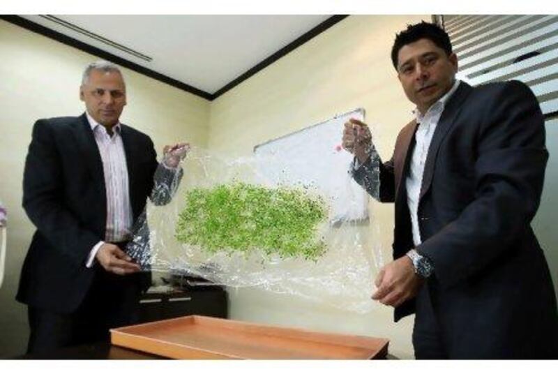 Yalman Khan, left, the chief executive of Agricel, and Kunal Wadhwani, a board member, show the technology in Dubai.