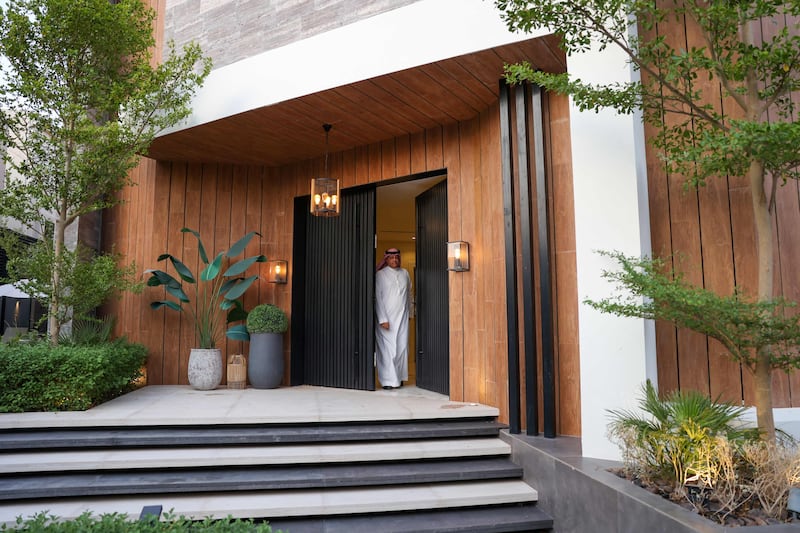 Haitham al-Madini opens the door to his recently renovated villa in the Saudi capital, Riyadh on June 22, 2022.  (Photo by Fayez Nureldine  /  AFP)