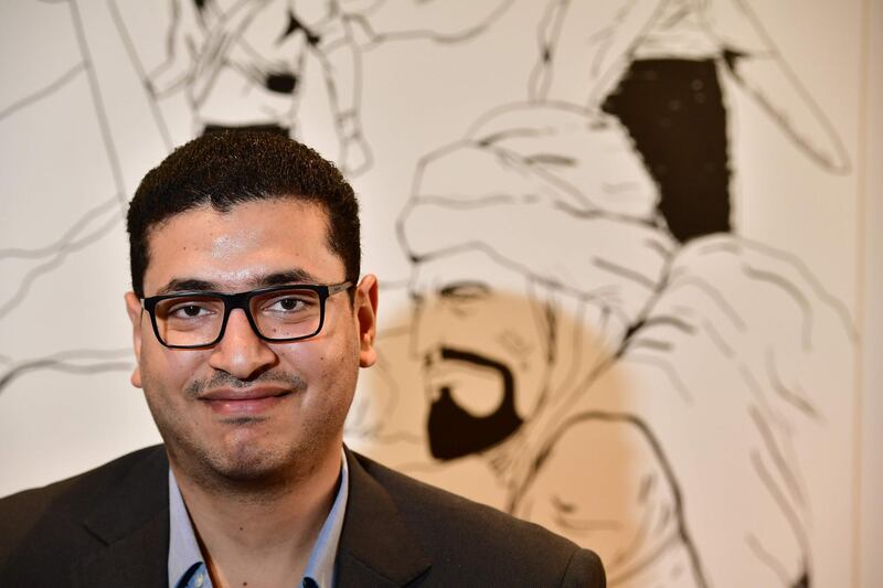 Comic artist Mumen Hilmi poses in his office in the Gulf emirate of Sharjah on September 18, 2018. Antara, an Arab poet and war hero who suffered from racism and rejection because of his dark skin color, is now a star of an Arabic comic book. / AFP / GIUSEPPE CACACE
