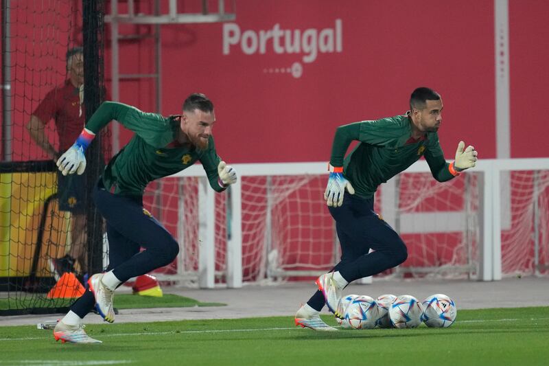 Portugal's goalkeepers Diogo Costa, right, and Jose Sa, left, warm up. AP