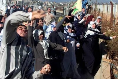 Lebanese students throw stones at Israeli soldiers at Fatima's Gate in Kfar Kila at the Lebanon-Israel border 10 November 2000 during a demonstration to support the Palestinian intifada, or uprising, against Israeli troops in the Palestinian territories that has taken 199 lives, most of them Palestinian, since a wave of violence exploded in late September.  AFP PHOTO/Ramzi HAIDAR