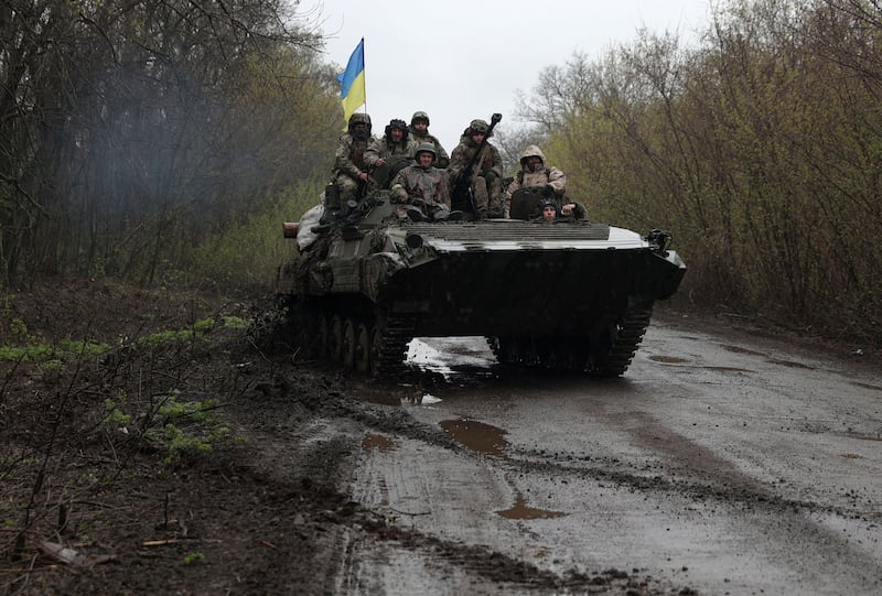 Ukrainian soldiers on an armoured personnel carrier, near the front line with Russian troops, in Izyum district, Kharkiv region, north-eastern Ukraine. AFP