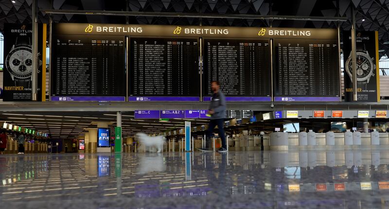 A departures board displays all flights as cancelled at a terminal inside Frankfurt airport. EPA