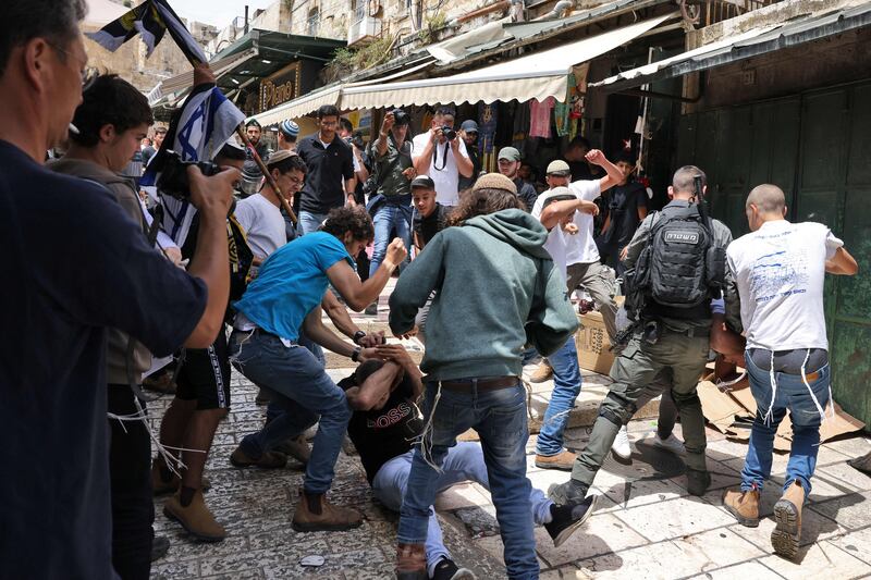 Israelis beat a Palestinian man in the Old City of Jerusalem. AFP