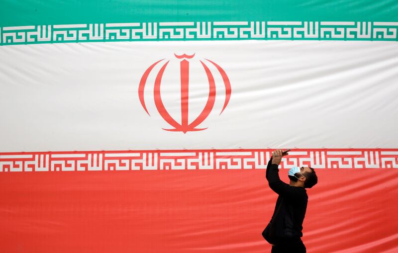 A man takes a selfie in front of the Iranian flag during a rally at Azadi Square in Tehran on February 11, marking the 43rd anniversary of the 1979 Islamic Revolution. EPA
