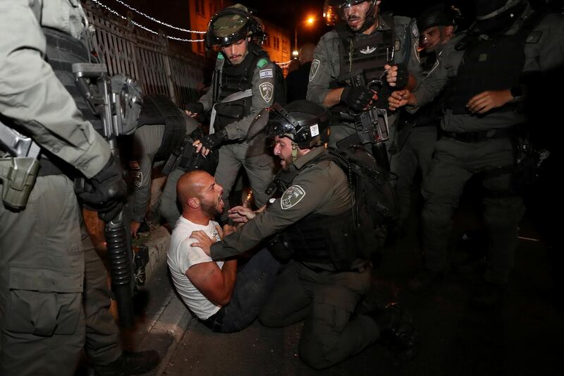 A Palestinian protester is detained during clashes with Israeli police, as the Muslim holy fasting month of Ramadan continues, in Jerusalem. Reuters