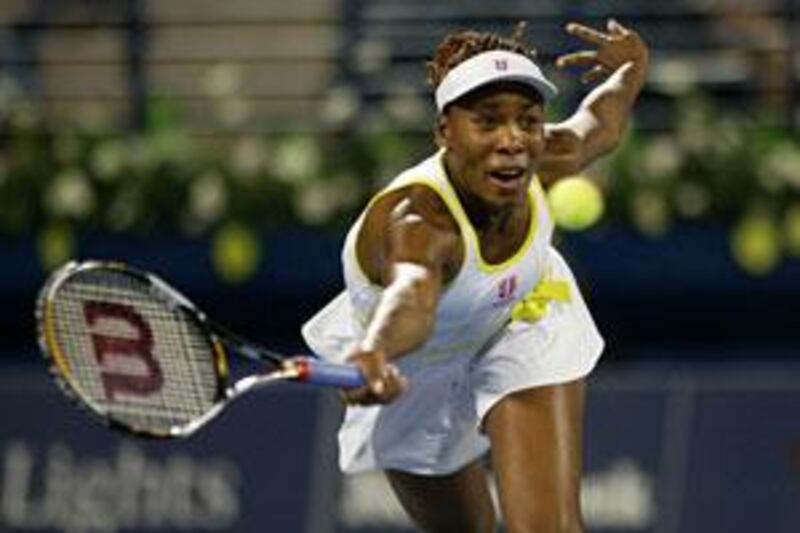 Venus Williams chases down a volley from sister Serena at the Dubai Tennis Championships.