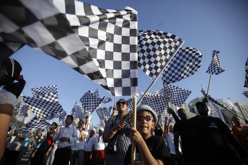Bushkar Nadella, 6, joins hundreds of people in Abu Dhabi attempt to break the Guinness World Record for The Most People Waving Checkered Flags as part of the Yasalam festival in Abu Dhabi October 24, 2013. Sammy Dallal / The National 