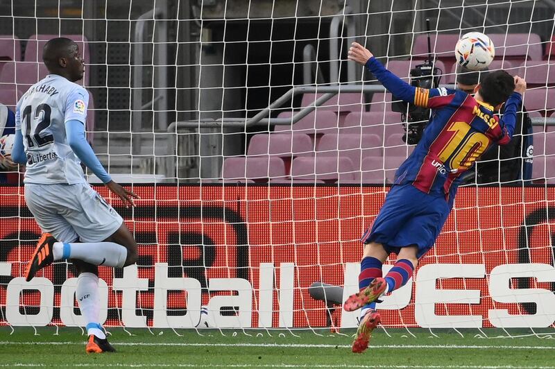 Lionel Messi heads the ball to score Barcelona's first goal against Valencia. AFP