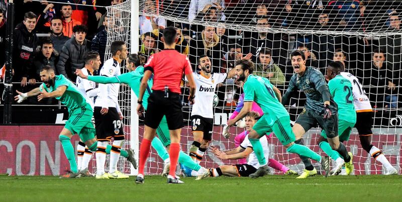 Real Madrid's Karim Benzema (L) celebrates after scoring equaliser against Valencia. EPA