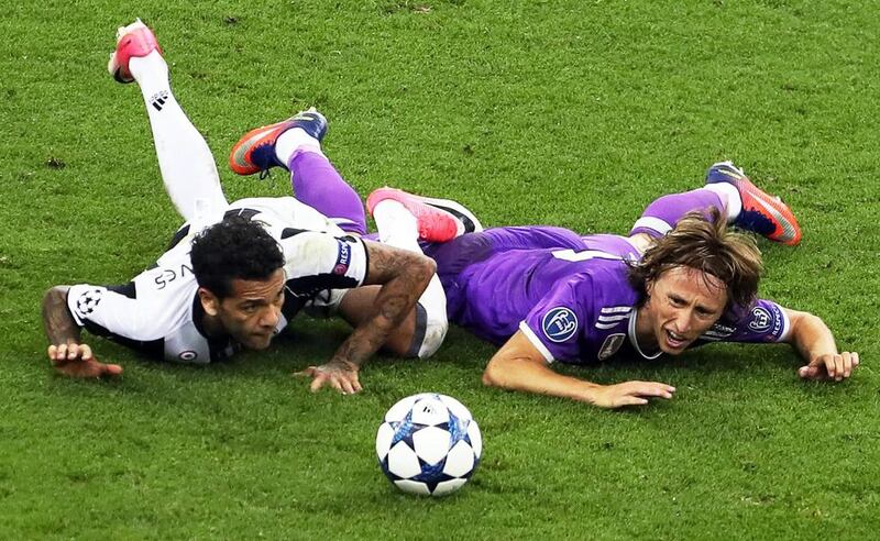 Real Madrid’s Luka Modric, right, in action against Juventus’ Dani Alves. Geoff Caddick / EPA