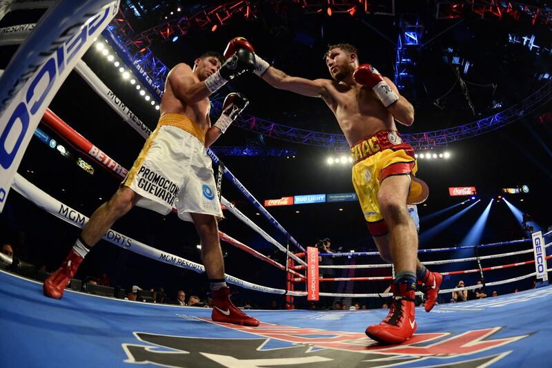 Alberto Guevara (white trunks) and Isaac Lowe (red/yellow trunks) box during their featherweight bout at MGM Grand Garden Arena, Las Vegas.  Reuters