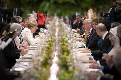 BUENOS AIRES, ARGENTINA - NOVEMBER 30: German Chancellor Angela Merkel talks to US President Donald Trump during the dinner for the participants and partners of the G20 Summit at the Colon Theatre in Buenos Aires, Argentina. (Photo by Guido Bergmann/Bundesregierung via Getty Images)