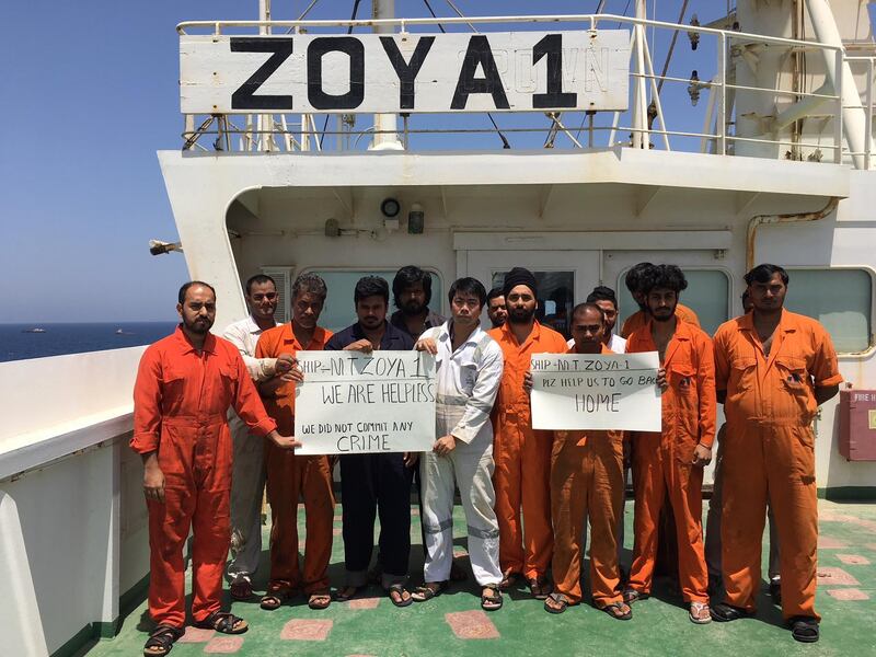 The crew of the Zoya stand on the deck of the supertanker having been stranded for more than a year off the coast of Sharjah. Zoya crew