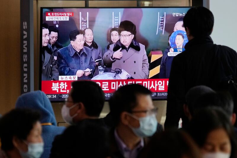Travellers at Seoul Railway Station watch a TV news report on North Korea's missile tests. AP