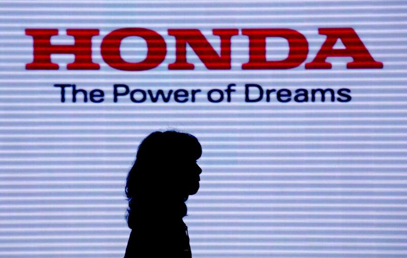 epa08714622 (FILE) - A visitor walks under the logo of Honda Motor Co. at the company headquarters in Tokyo, Japan, 29 July 2014 (reissued 02 october 2020). According to media reports, Honda announced it will quit Formula 1 to focus on carbon neutrality at the end of the 2021 season, forcing Alpha Tauri and Red Bull to look for a new engine provider for 2022.  EPA/KIMIMASA MAYAMA