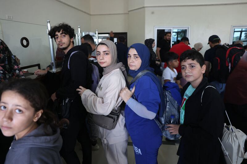 Foreigners and Palestinians with dual citizenship prepare to cross the Rafah border into Egypt from Gaza on Friday. AFP