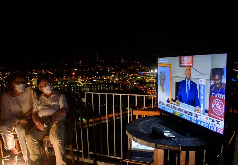Guests watch television coverage of the Democratic National Convention at a virtual DNC party overlooking the city on August 18, 2020 in Pittsburgh, Pennsylvania. AFP