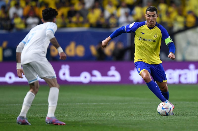 Al Nassr's Portuguese forward Cristiano Ronaldo runs at Al Batin's Saudi midfielder Yousef Al Shammari during the Saudi Pro League match at the Mrsool Park in Riyadh on March 3, 2023. Nassr won the match 3-1. AFP