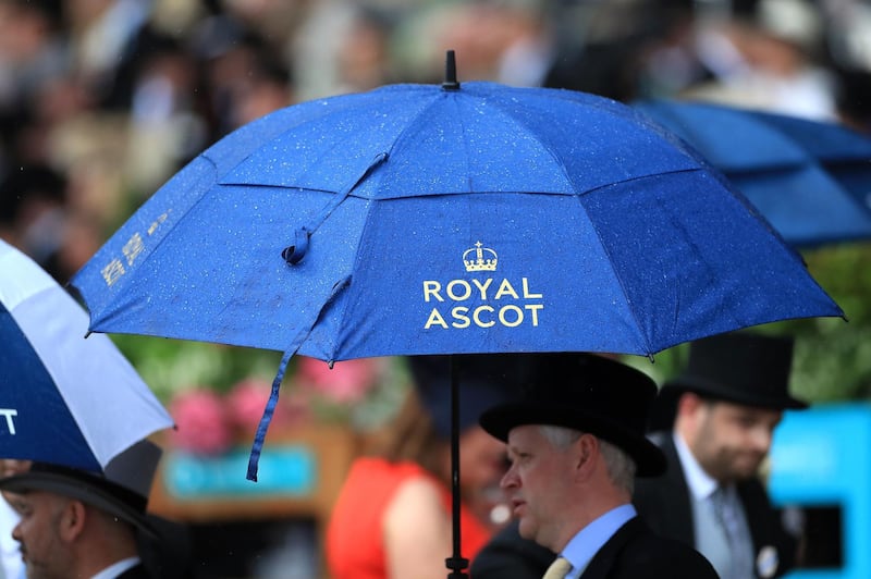 Racegoers hold umbrellas in the rain during Day 1 of Royal Ascot. Press Association