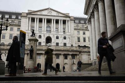 Pedestrians walk by the Royal Exchange and the Bank of England in the City of London on December 11, 2020.  A Brexit trade deal between Britain and the European Union looked to be hanging in the balance on Friday, after leaders on both sides of the Channel gave a gloomy assessment of progress in last-gasp talks. The Bank of England said Friday that UK banks remained "resilient" to the risks of Brexit and coronavirus, but warned financial services could face "disruption" when the transition period ends. / AFP / Tolga Akmen
