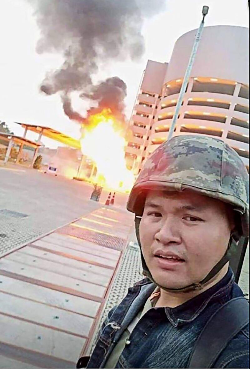 A screenshot from the Facebook livestream video of Jakrapanth Thomma shows him standing in front of a building on fire during a gun rampage in Nakhon Ratchasima in north-east Thailand. AFP / Social media