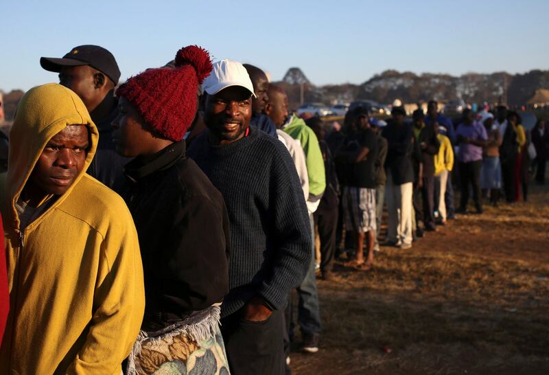 Zimbabwean voters queue to cast their ballots in the country's general elections in Harare, Zimbabwe. REUTERS / Siphiwe Sibeko