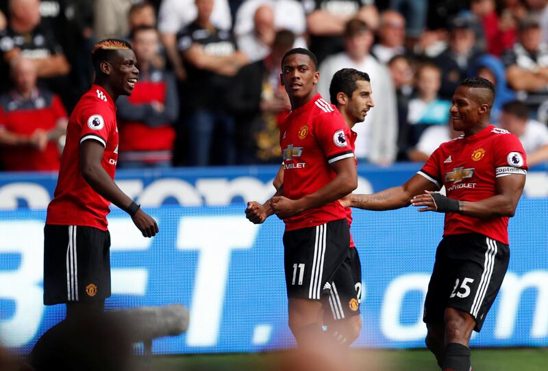 Football Soccer -  Premier League - Swansea City vs Manchester United - Swansea, Britain - August 19, 2017   Manchester United's Paul Pogba celebrates scoring their third goal with Anthony Martial and team mates    Action Images via Reuters/Andrew Boyers     EDITORIAL USE ONLY. No use with unauthorized audio, video, data, fixture lists, club/league logos or "live" services. Online in-match use limited to 45 images, no video emulation. No use in betting, games or single club/league/player publications. Please contact your account representative for further details.