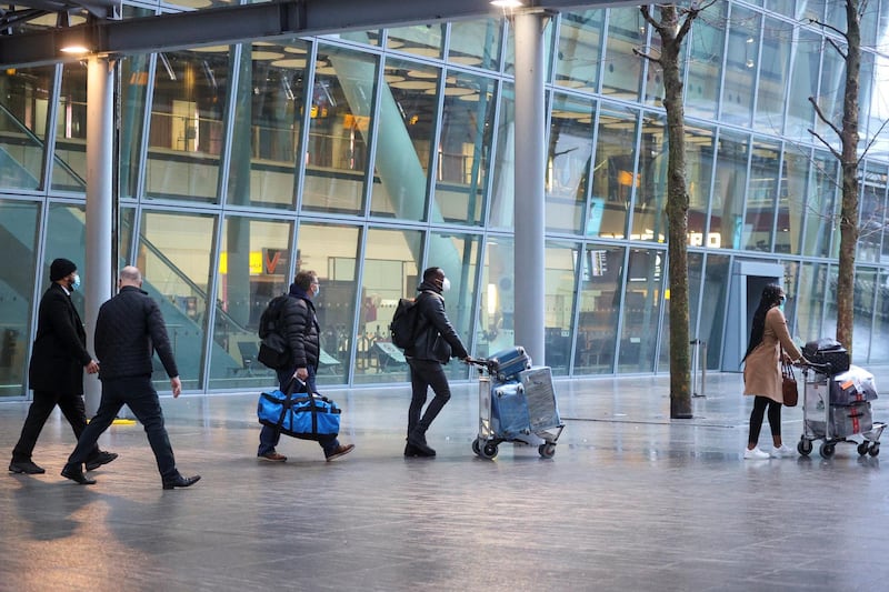 Travellers walk outside Heathrow Airport. Reuters