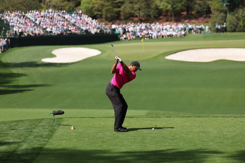 Woods  hits his tee shot on the fourth hole. EPA