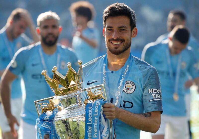 Soccer Football - Premier League - Brighton & Hove Albion v Manchester City - The American Express Community Stadium, Brighton, Britain - May 12, 2019  Manchester City's David Silva poses with the trophy as he celebrates winning the Premier League           Action Images via Reuters/John Sibley  EDITORIAL USE ONLY. No use with unauthorized audio, video, data, fixture lists, club/league logos or "live" services. Online in-match use limited to 75 images, no video emulation. No use in betting, games or single club/league/player publications.  Please contact your account representative for further details.