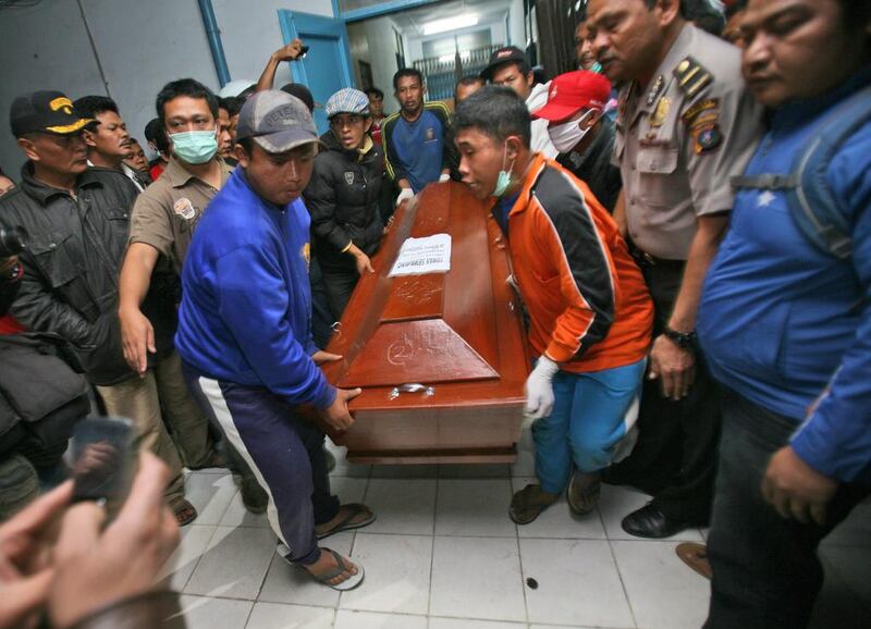 Relatives carry a coffin containing the body a victim of the eruption. Binsar Bakkara / AP Photo