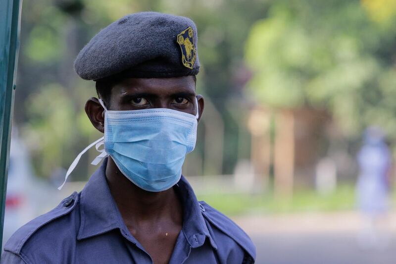 A security guard wears a protective mask at the entrance gate of the National Institute of Infectious Diseases, commonly called the Infectious Diseases Hospital (IDH), where one Chinese citizen has been placed in isolation and is being closely monitored after testing positive for coronavirus, in the suburbs of Colombo, Sri Lanka.  EPA
