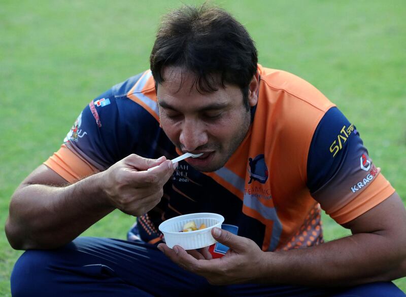 Players break their fast before the Sharjah Ramadan Cup game between MGM Cricket Club v Pacific Group in Sharjah on April 27th, 2021. Chris Whiteoak / The National. 
Reporter: Paul Radley for Sport