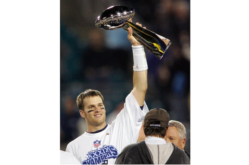 New England Patriots quarterback Tom Brady raises the Vince Lombardi Trophy after they beat the Philadelphia Eagles, 24-21, in the 2005 Super Bowl. AP