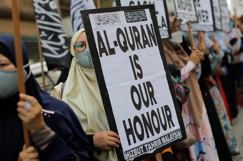 A protest in front of the Swedish embassy after Rasmus Paludan, leader of Danish far-right political party Hard Line, burned a copy of the Quran near the Turkish Embassy in Stockholm, in Kuala Lumpur, Malaysia, on January 27. Reuters