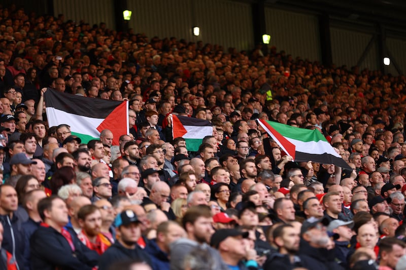 Football fans inside Anfield stadium hold up Palestine flags during the Liverpool-Everton derby on Saturday. Reuters