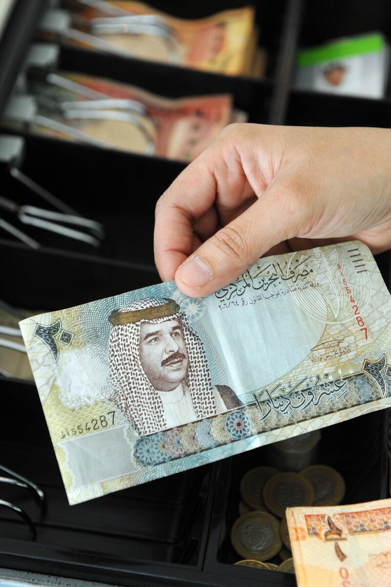 Kingdom Bahrain, Manama, 25/8/10. Bahrain currency in cash reatail till  Photo by Phil Weymouth